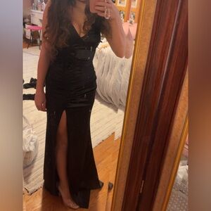 cute black dress with long slit and two flowers by shoulder and hip